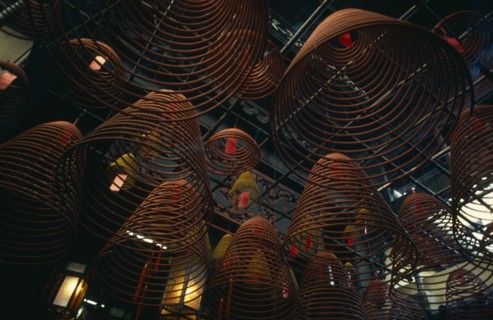 HONG KONG, Central District, Man Mo Temple, Spiral cones of incense hanging from roof of the Man Mo