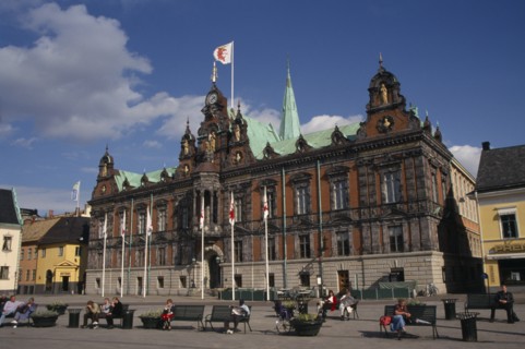 SWEDEN, Malmo, Stortorget City Hall exterior with people sat on benches outside
