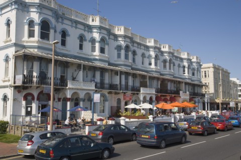 ENGLAND, West Sussex, Worthing, Bars and restaurants lining Marine Parade by seafront