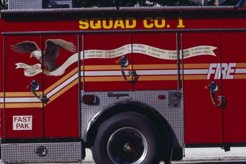 USA, New York, New York City, Part view of fire engine painted with Bald Eagle carrying banner