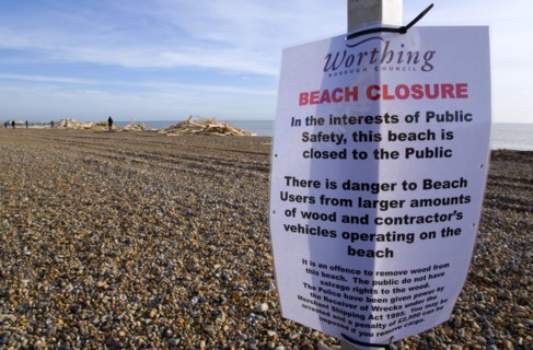 ENGLAND, West Sussex, Worthing, Timber washed up on the beach from the Greek registered Ice