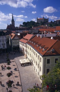 SLOVAKIA, Bratislava, "View over paved square and cafe, across red tiled rooftops of the Old Town
