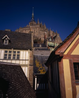 FRANCE, Normandy, Mont-St-Michel, The Abbey on hilltop above houses seen from Liberty Tower.