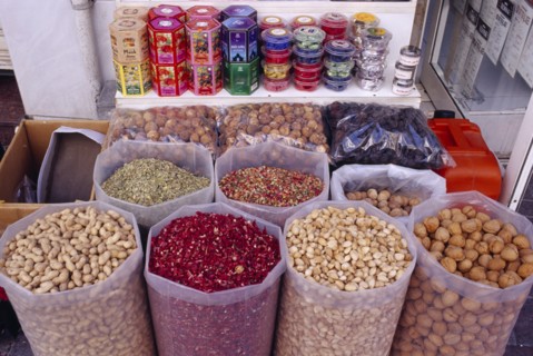 UAE, Dubai, Deira, Old souq in Eastern side of the town with sacks of nuts and flower petals