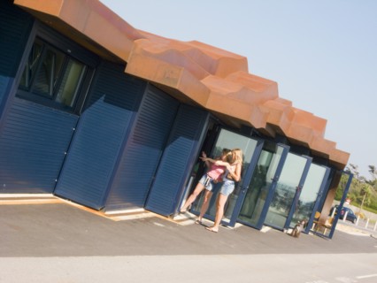 ENGLAND, West Sussex, Littlehampton, Two women standing by glass door at the East Beach Cafe