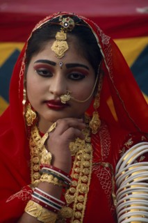 INDIA, Rajasthan, Jaisalmer, Portrait of a Miss Desert contestant wearing red with traditional