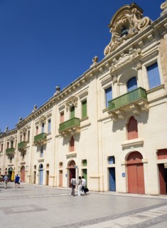 MALTA, Valletta, People walking by the waterfront redevelopment of old Baroque Pinto wharehouses