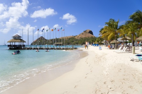 WEST INDIES, St Lucia, Gros Islet , Tourists on the beach at Sandals Grande St Lucian Spa and Beach