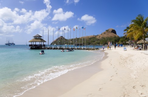 WEST INDIES, St Lucia, Gros Islet , Tourists on the beach at Sandals Grande St Lucian Spa and Beach