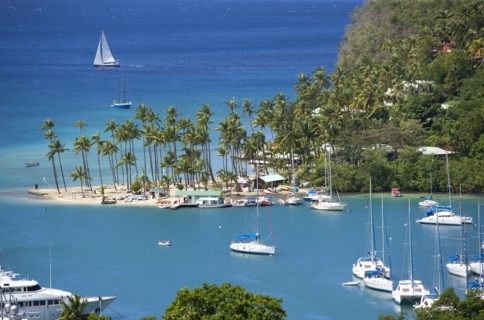WEST INDIES, St Lucia, Castries , Marigot Bay The harbour with yachts at anchor and a yacht sailing