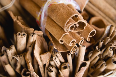 WEST INDIES, St Lucia, Castries, Market spice stall with cinnamon or cassia bark herbs tied in