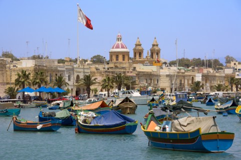 MALTA, Marsaxlokk , Fishing village harbour on the south coast with colourful Kajjiki fishing boats