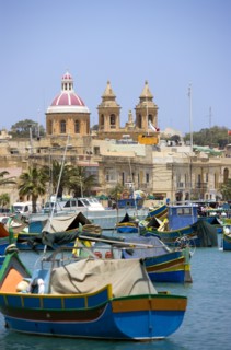 MALTA, Marsaxlokk , Fishing village harbour on the south coast with colourful Kajjiki fishing boats