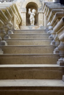 MALTA, Mdina, The Silent City. Statue of a cherub at the top of stone steps in the Fontanella