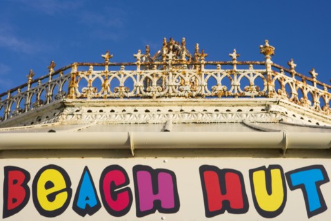 ENGLAND, East Sussex, Brighton, Beach hut sign above shop at the promenade end of the former West