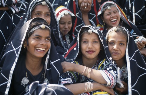 INDIA, Rajasthan, Alwar, Group of young dancers smiling and laughing at the Alwar Utsav Festival