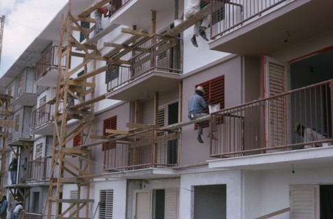 CUBA, Industry, Construction workers and painters on wooden scaffolding working on muli-storey
