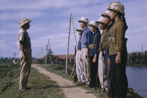 VIETNAM, North , War, Line of male and female Viet Cong soldiers standing in front of superior