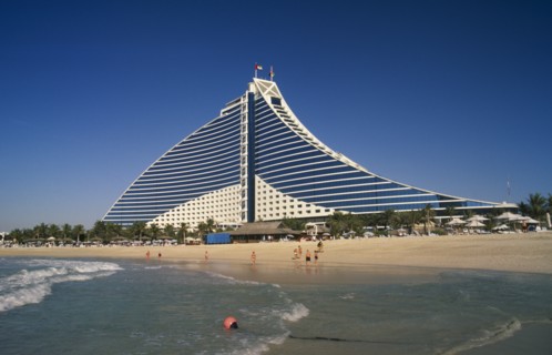 UAE, Dubai , Jumeirah Beach Hotel with people on private beach in foreground.
