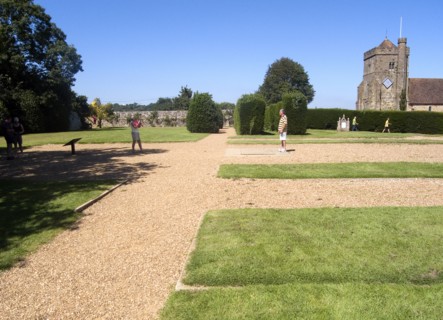 ENGLAND, East Sussex, Battle, Battle Abbey. Visitors in grounds of partially ruined abbey complex