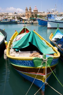 MALTA, Marsaxlokk , Fishing village harbour on the south coast with colourful Kajjiki fishing boats