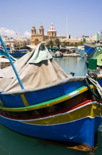 MALTA, Marsaxlokk , Fishing village harbour on the south coast with colourful Kajjiki fishing boats