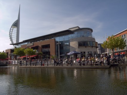 ENGLAND, Hampshire, Portsmouth, "Gunwharf Quays complex. View across water towards restaurants,