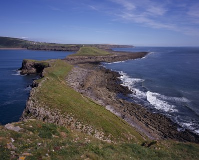 WALES, Swansea, Gower Peninsula, View east from the Worm’s Head towards the mainland.  Sloping