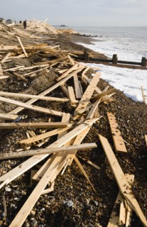 ENGLAND, West Sussex, Worthing, Timber wood planks washed up on the beach seafront from the