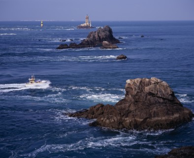 FRANCE, Brittany, Finistere, "Pointe du Raz.  Jagged outcrops of offshore rock protruding from sea