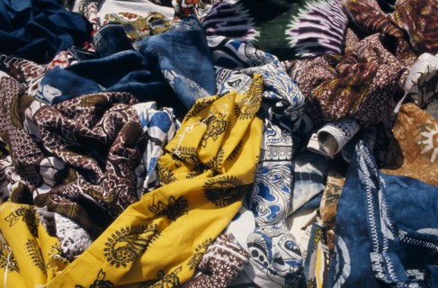 SENEGAL, Dakar, Local dyed and printed fabrics for sale in market.