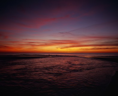 FRANCE, Aquitaine, Landes, Cap de L’Homy.  Red and orange sunset sky over Atlantic coastline with