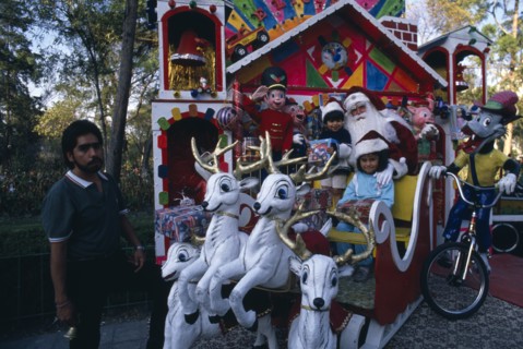 MEXICO, Mexico City, Children visiting Father Christmas in his sleigh in Mexico City Park