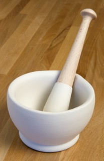HOUSEHOLD, Kitchenware, Cooking, White ceramic pestle and mortar on a wooden kitchen surafce