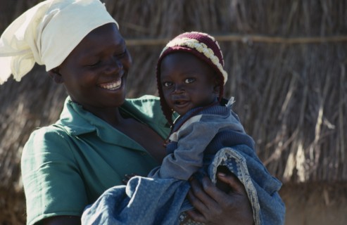 20088800 MOZAMBIQUE  People Portrait of laughing young woman carrying child  refugees repatriated from Zimbabwe through the UNHCR  the UN High Commissioner for Refugees.