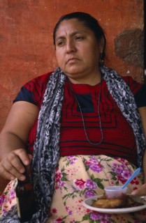 MEXICO, Oaxaca, Juchitan, Matriarchal society.  Portrait of seated women holding bottle and plate
