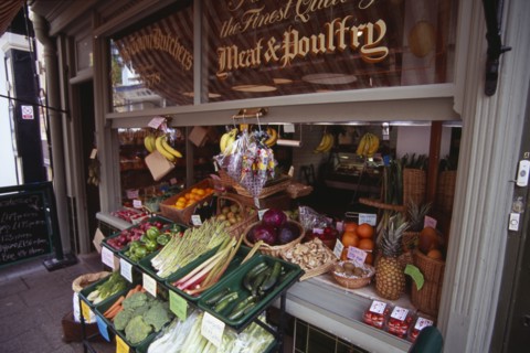 ENGLAND, East Sussex, Hastings, Old Town Butchers on George Street.  Shop frontage with fruit and