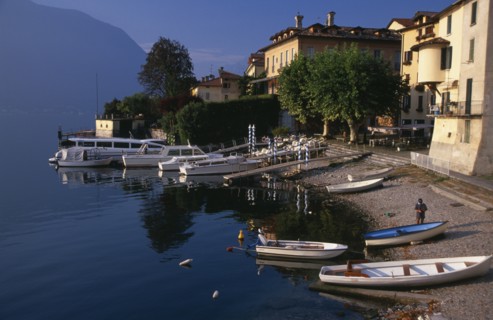 ITALY, Lombardy, Lake Como, Sala Comacina.  Fishing village with motor boats moored against wooden
