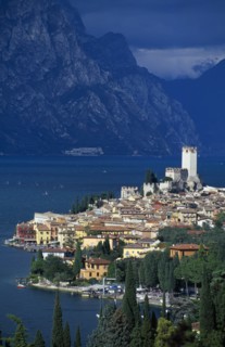 ITALY, Veneto, Lake Garda , Malcesine.  Tiled rooftops and pastel coloured buildings of town and
