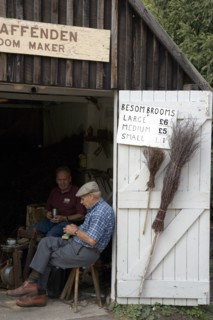ENGLAND, West Sussex, Amberley, Amberley Working Museum. The Broom maker workshop with two men