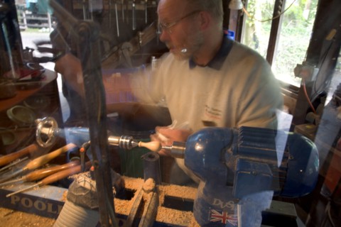 ENGLAND, West Sussex, Amberley, Amberley Working Museum. The West Sussex Woodturners with a man