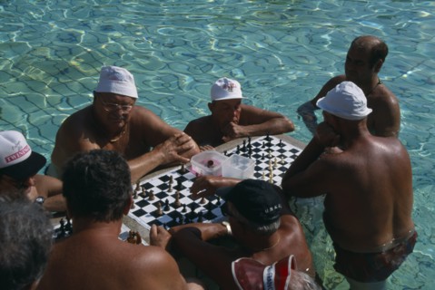 HUNGARY, Budapest, Szecheny Baths. A group of men playing a game of Chess in the thermal water