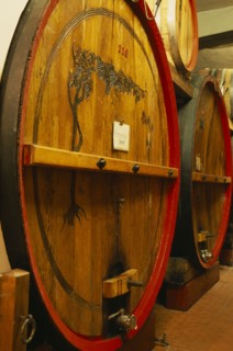 ITALY, Veneto, Lake Garda, Bardolino.  Large wooden wine casks in cellar at the Museum of Wine.