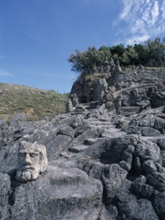 FRANCE, Brittany, St Malo, Rochers Sculptes de Rotheneuf. Sculptures of faces carved into rock