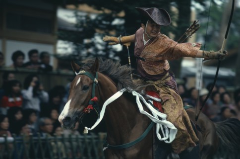 JAPAN, Honshu, Kamakura, Yabusame mounted archery at Hachimangu shrine festival.  Horseback archery