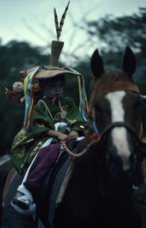 JAPAN, Honshu, Kyoto, Gion Festival.  A young boy dressed as a courtier of the Heian period