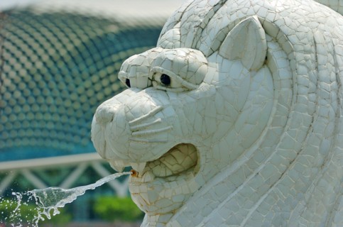 SINGAPORE, MERLION STATUE, " SITUATED INFRONT OF THE FULLERTON HOTEL AND FINACIAL DISTRICT BEHIND.