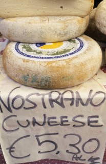 ITALY, Lake Garda Area, Display of nostrano cheeses for sale with price in euros.