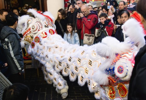 ENGLAND, London, Chinatown, Lion Dance troupe and embroidered banners in Gerrard Street amongst the