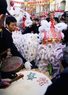 ENGLAND, London, Chinatown, Lion Dance troupe performing in Wardour Street amongst the crowd